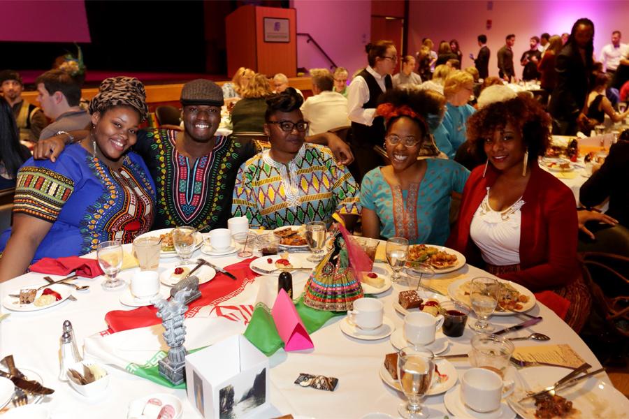 Students sit at a table during the International Dinner.