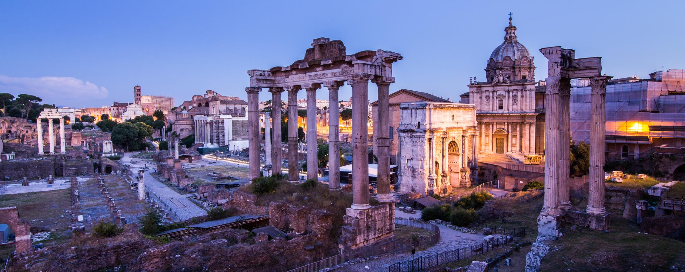 Photo of ancient ruins with columns during a sunset.