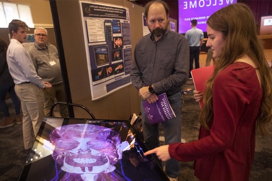 A student works with a faculty member during Undergraduate Research Day.