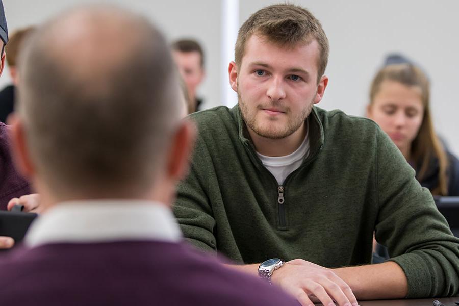 student listening to a professor