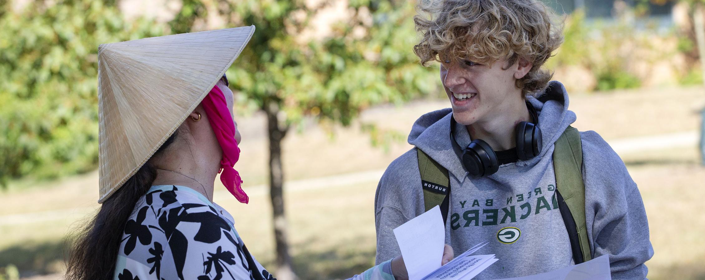 Two people look at a flyer.